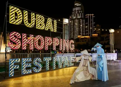 two people dressed in costumes standing in front of a sign at Quasi-Hotels Zada Cozy Lux in Business Bay 1BR in Dubai