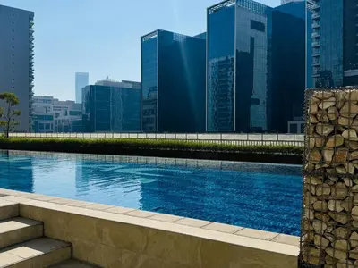 a swimming pool in a city with tall buildings at Cozy 1 BR in Business Bay Dubai by GP Holiday Homes in Dubai