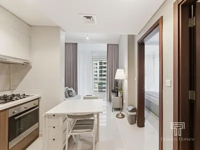 a kitchen with white counters and a white counter top at Cozy 1 BR in Business Bay Dubai by GP Holiday Homes in Dubai