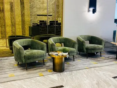 a waiting room with three chairs and a table at Cozy 1 BR in Business Bay Dubai by GP Holiday Homes in Dubai