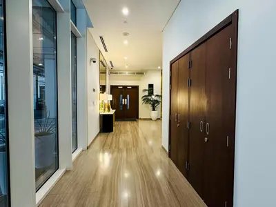a hallway with wooden floors and a door at Cozy 1 BR in Business Bay Dubai by GP Holiday Homes in Dubai