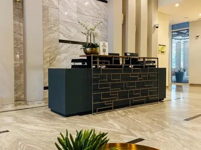 a lobby with a reception desk in a building at Cozy 1 BR in Business Bay Dubai by GP Holiday Homes in Dubai