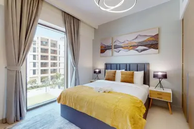 a bedroom with a bed and a large window at Vacationer I Premium One Bed with Skyline Views I Summer Creek Beach Tower 2, Dubai Creek Harbour in Dubai