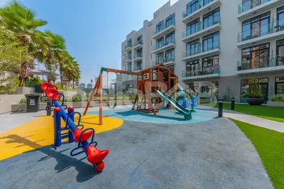 a playground in front of a apartment building at Le Petit Village !Cozy Yet Spacious Studio Apartment! in Dubai