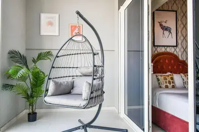 a swinging chair in a room with a bedroom at Reva tower- 2BR Dubai mall walking & canal facing in Dubai