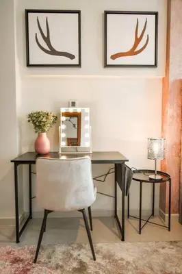 a desk with a chair and a mirror and a lamp at Reva tower- 2BR Dubai mall walking & canal facing in Dubai