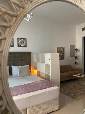 a bedroom with a bed and a mirror at Spacious Studio Apartment in Dubai Marina with Balcony in Dubai