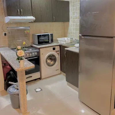 a kitchen with a stainless steel refrigerator and a dishwasher at Spacious Studio Apartment in Dubai Marina with Balcony in Dubai