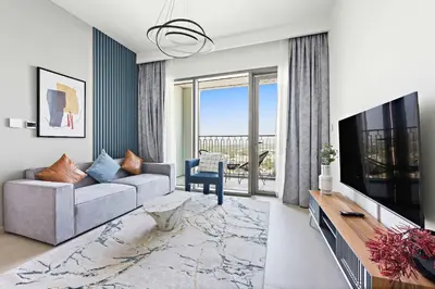 a living room with a couch and a tv at Silkhaus chic 1BDR in the heart of Downtown in new tower in Dubai