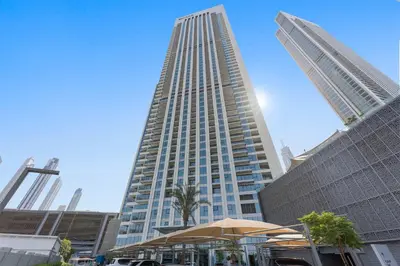 a tall building with an umbrella in front of it at Silkhaus chic 1BDR in the heart of Downtown in new tower in Dubai
