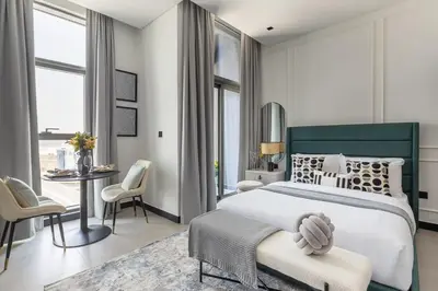 a bedroom with a bed and a table and chairs at Frank Porter - 15 Northside Tower 1 in Dubai