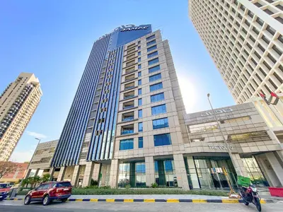 a car parked in front of a building at Chic 1BR Apt with Sofa Bed, Pool & Burj Khalifa View in Dubai