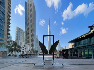 a statue of an eagle on a city street at Trophy - Euphoria Eclipse Suite in 29th floor in Burj Royale in Dubai