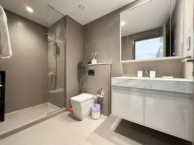 a bathroom with a shower and a toilet and a sink at Trophy - Euphoria Eclipse Suite in 29th floor in Burj Royale in Dubai