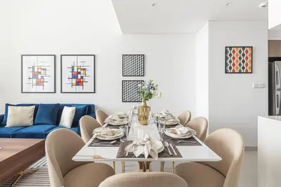a dining room with a white table and chairs at Frank Porter - The Grand in Dubai