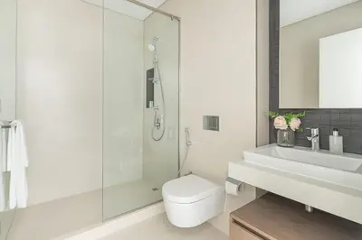 a bathroom with a toilet and a sink and a shower at Frank Porter - The Grand in Dubai
