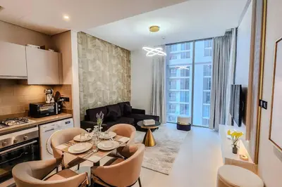 a kitchen and living room with a table and chairs at STAY BY LATINEM Luxury 1BR Holiday Home CVR A702 near Burj Khalifa in Dubai