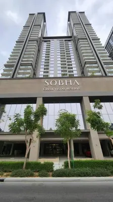 a tall building with trees in front of it at STAY BY LATINEM Luxury 1BR Holiday Home CVR A702 near Burj Khalifa in Dubai