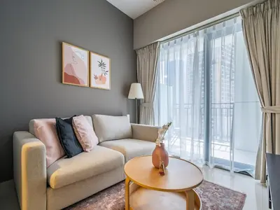 a living room with a couch and a large window at Business Bay's Coziest Hideaway With Balcony in Dubai