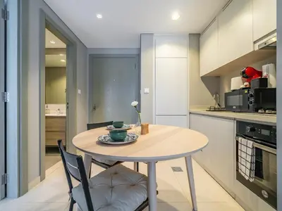 a kitchen with a table and chairs in a room at Business Bay's Coziest Hideaway With Balcony in Dubai