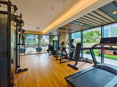 a gym with treadmills and ellipticals in a building at Business Bay's Coziest Hideaway With Balcony in Dubai