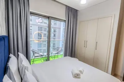 a bedroom with a bed and a large window at STAY BY LATINEM Luxury 1BR Holiday Home CVR A703 near Burj Khalifa in Dubai