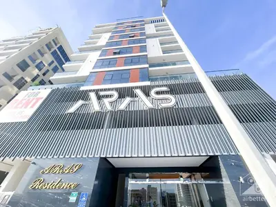 a tall building with a msg sign on it at Spacious Studio with balcony in AL Majan in Dubai