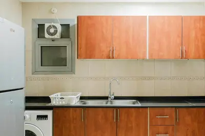a kitchen with a sink and a dishwasher at RH- Exquisite & Spacious 01 BR, Near Mall of the Emirates in Dubai