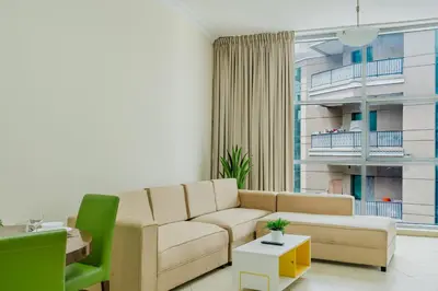 a living room with a couch and a table at RH- Exquisite & Spacious 01 BR, Near Mall of the Emirates in Dubai