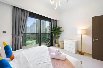 a bedroom with a large bed with a large window at Extravagant 3BR + kid's room w/ Burj Khalifa view in Dubai