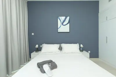 a bedroom with a bed with a shirt on it at Waterfront With Stunning View! in Dubai