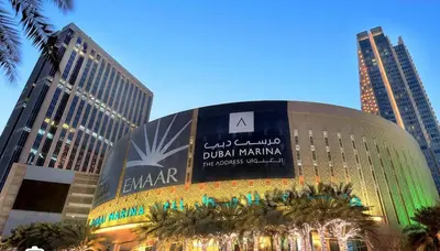 a building with a sign on it in a city at Dubai Marina larivera in Dubai