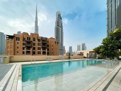 a swimming pool in the middle of a city with tall buildings at Vogue Downtown Burj Royale near Dubai Mall and Burj Khalifa ,Two Bedroom Apartment with large Balcony and Access to all Amenities in Dubai