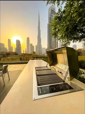 a laptop sitting on a table on top of a building at Vogue Downtown Burj Royale near Dubai Mall and Burj Khalifa ,Two Bedroom Apartment with large Balcony and Access to all Amenities in Dubai