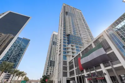 two tall buildings in a city with palm trees at ALiving Classy Private Studio I Canal Views I DAMAC Maison Prive A- 2111 in Dubai