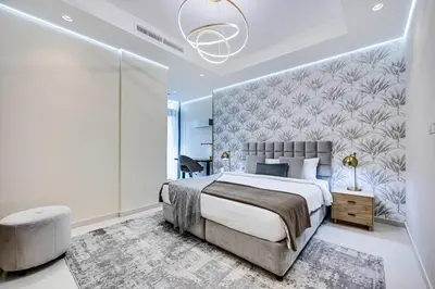 a bedroom with a large bed with a large wall at Elegant apartment in Paramount Midtown residence in Dubai