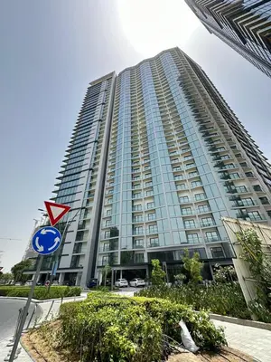 a tall building with a street sign in front of it at EasyGo - Sobha Waves 1 Bedroom & Study Modern in Dubai