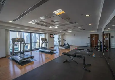a gym with several treadmills and machines in a room at Cosmos Living Spacious with Balcony GCV1 in Dubai