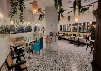 a restaurant with tables and chairs in a room at Cosmos Living Spacious with Balcony GCV1 in Dubai