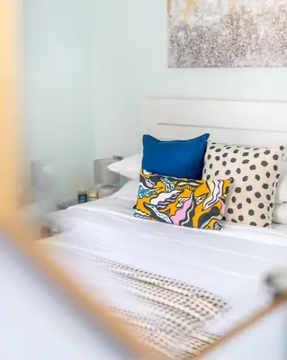 a white bed with two pillows on top of it at GuestReady - Springs Serenity near Golf Club in Dubai