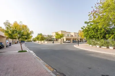 an empty street in a town with houses and trees at GuestReady - Springs Serenity near Golf Club in Dubai