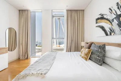 a white bedroom with a large bed and windows at GuestReady - Majestic Ain Dubai from your balcony in Dubai
