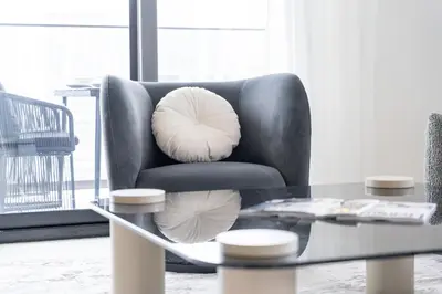 a living room with a chair and a coffee table at Canal front apartment with Burj Khalifa view by Suiteable in Dubai