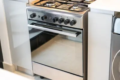 a stainless steel oven in a kitchen at Canal front apartment with Burj Khalifa view by Suiteable in Dubai