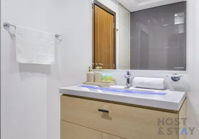 a bathroom with a sink and a mirror at Studio in Jasmine, Damac Hills - Host & Stay in Dubai