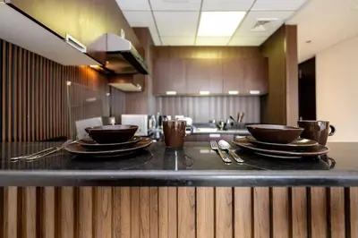 a kitchen with two bowls and plates on a counter at Special Rates - Elegant Studio - Golf Views in Dubai