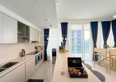 a kitchen with a counter with a table in it at Sunrise Bay 3BR EMAAR Beachfront Dubai Harbour by Rich Stay in Dubai