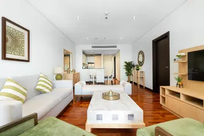 a living room with a white couch and a table at Lux BnB I Palm Jumeirah Resort I Palm Views in Dubai