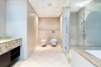 a bathroom with a shower and a toilet at Lux BnB I Palm Jumeirah Resort I Palm Views in Dubai