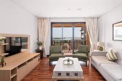 a living room with a couch and a tv at Lux BnB I Palm Jumeirah Resort I Palm Views in Dubai